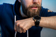 © phoenix021 - Young hipster man, talking in to smart watch closeup shot