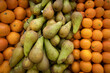 Gennevilliers, France - 01 21 2022: Primeur fruits and vegetables. Detail of mixed pears and oranges at a greengrocer
