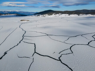 Aerial winter view of Batak Reservoir covered with ice, Bulgaria