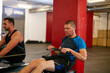 © D Laflor/peopleimages.com - Rowing to get ripped. Cropped shot of two men working out on the rowing machine at the gym.