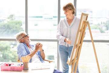 Wall Mural - senior couple artist talking about painting work in office