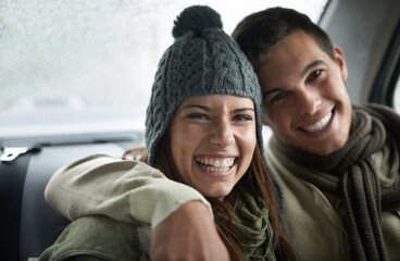 Wall Mural - Warmed by love. A young couple sitting in their car while it rains.