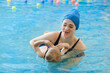 © ninelutsk - Toddler child learning to swim in indoor swimming pool with teacher. Floating in the water, balancing and general physical activity for kids, early development. Boy kid trained to kick legs and float