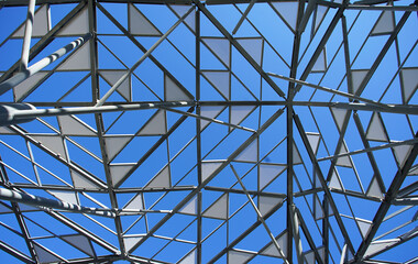 Sticker - Decorative roof in the shape of a triangle in a park square with a clear blue sky