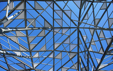 Canvas Print - Decorative roof in the shape of a triangle in a park square with a clear blue sky