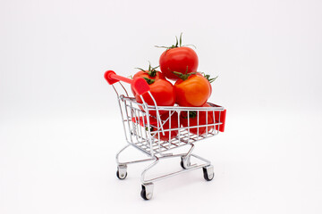 Tomatoes in metal basket on white background