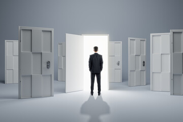 Businessman standing in front of abstract white puzzle door in interior. Future, choice, success, direction, opportunity and solution concept.