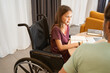 © Svitlana - Girl in a wheelchair is studying with an adult male