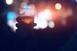 © astrosystem - Person holding cold beer plastic cup on a music festival.