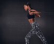 © Anne B/peopleimages.com - Upper body strength at its best. Studio shot of a beautiful young woman working out against a black background.