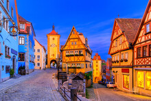 Rothenburg Ob Der Tauber, Bavaria, Germany. Medieval Town Of Rothenburg At Night. Plonlein(Little Square) And The Two Towers Of The Old City Wall.
