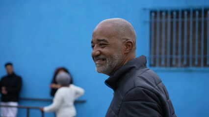 Wall Mural - A senior African American person walking outside in street portrait face