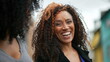 © Marco - A happy black woman laughing and smiling a casual hispanic 40s lady real life laugh and smile