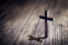 Religious Crucifix Cross Upright On Wooden Table Background