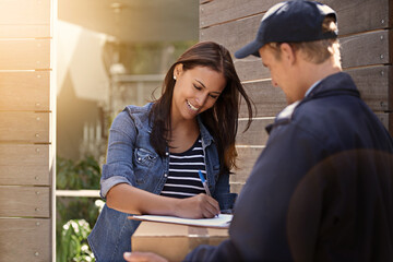 Canvas Print - All I need is a signature. Cropped shot of a young woman receiving a delivery.