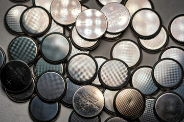 CR2032 coin cell batteries background closeup pan slide