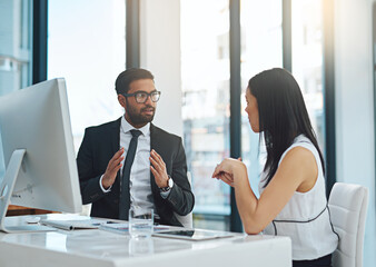 Sharing his vision with his colleague. Cropped shot of two young businesspeople having a discussion while working in a modern office.