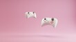 3d image of a couple gamepads on a beautiful pink pastel background