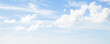 White clouds over blue sky on a summer day, panoramic photo