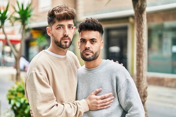 Young couple hugging each other with relaxed expression at street