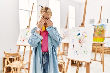 Poster - Young caucasian girl at art studio rubbing eyes for fatigue and headache, sleepy and tired expression. vision problem