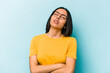 © Asier - Young hispanic woman isolated on blue background tired of a repetitive task.