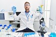 © Krakenimages.com - Middle age man working at scientist laboratory relax and smiling with eyes closed doing meditation gesture with fingers. yoga concept.