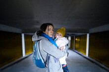 Frightened Mother And Her Child In The Underground Shelter