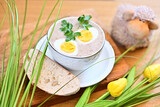 Fototapeta Tulipany - Traditional Polish soup served with bread and eggs. Easter decoration. Sour soup