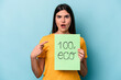 © Asier - Young caucasian woman holding 100% eco placard isolated on blue background pointing to the side
