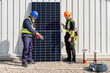 © Westend61 - Colleagues standing by solar panel at power station