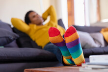 Woman Wearing Multi Colored Socks In Living Room