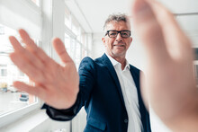 Businessman Doing High-five With Colleague In Office