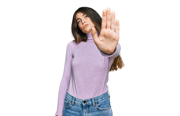 Poster - Young beautiful teen girl wearing turtleneck sweater doing stop sing with palm of the hand. warning expression with negative and serious gesture on the face.