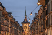 Switzerland, Canton Of Bern, Bern, Street Lights And Power Lines Stretching Over Old Town Street At Dusk With Zytglogge Clock Tower In Background