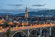 Switzerland, Canton Of Bern, Bern, Kornhausbrucke Bridge At Dusk With Bell Tower Of Cathedral Of Bern In Background