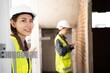 © Chalermphon - worker woman wears a white hard hat look up.female construction inspector reviews a masonry during home inspection as she holding clipboard.team civil engineerใTwo women work together to inspect.