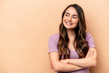 Young Caucasian Woman Isolated On Beige Background Smiling Confident With Crossed Arms.