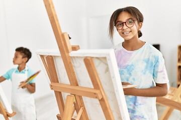 Brother and sister smiling confident drawing at art studio