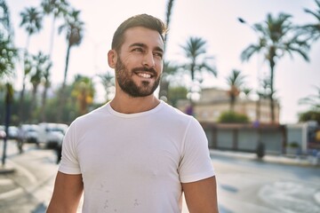 Sticker - Young hispanic man smiling confident walking at street