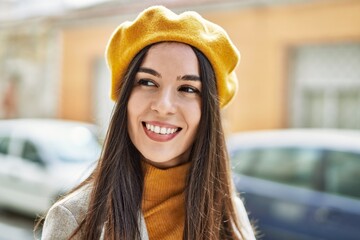 Wall Mural - Young hispanic girl smiling happy standing at the city.