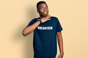 Young african american man wearing volunteer t shirt cutting throat with hand as knife, threaten aggression with furious violence