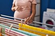 © Krakenimages.com - Young latin woman pregnant hanging clothes on clothesline at laundry room