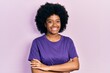 © Krakenimages.com - Young african american woman wearing casual clothes happy face smiling with crossed arms looking at the camera. positive person.