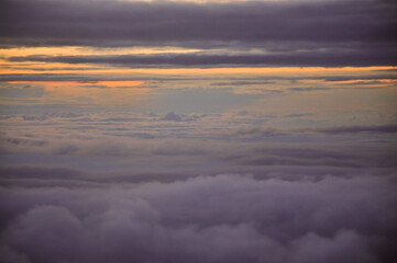 cloudy sky in the late afternoon, the last streaks of sunshine show an orange to purple degradation