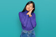 © Krakenimages.com - Beautiful young asian woman wearing casual clothes sleeping tired dreaming and posing with hands together while smiling with closed eyes.