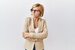 © Krakenimages.com - Middle age blonde business woman standing over isolated background looking to the side with arms crossed convinced and confident