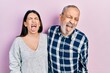 © Krakenimages.com - Hispanic father and daughter wearing casual clothes sticking tongue out happy with funny expression. emotion concept.