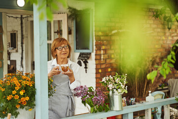 Pretty mature houswife drinking tea on terrace