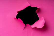 Torn Hole In Pink Paper